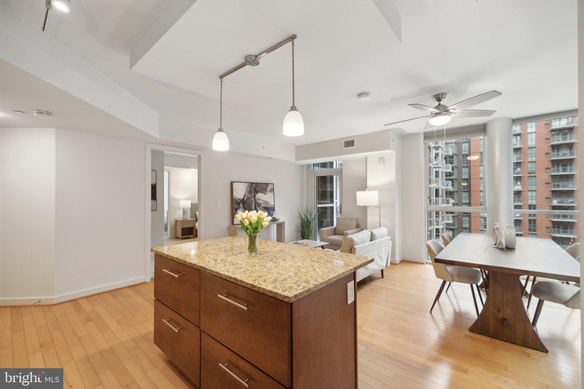 1025 First Street Southeast, Unit 716 Washington, DC 20003 - Photo 27 of 27 a view of a kitchen counter top space with furniture and wooden floor