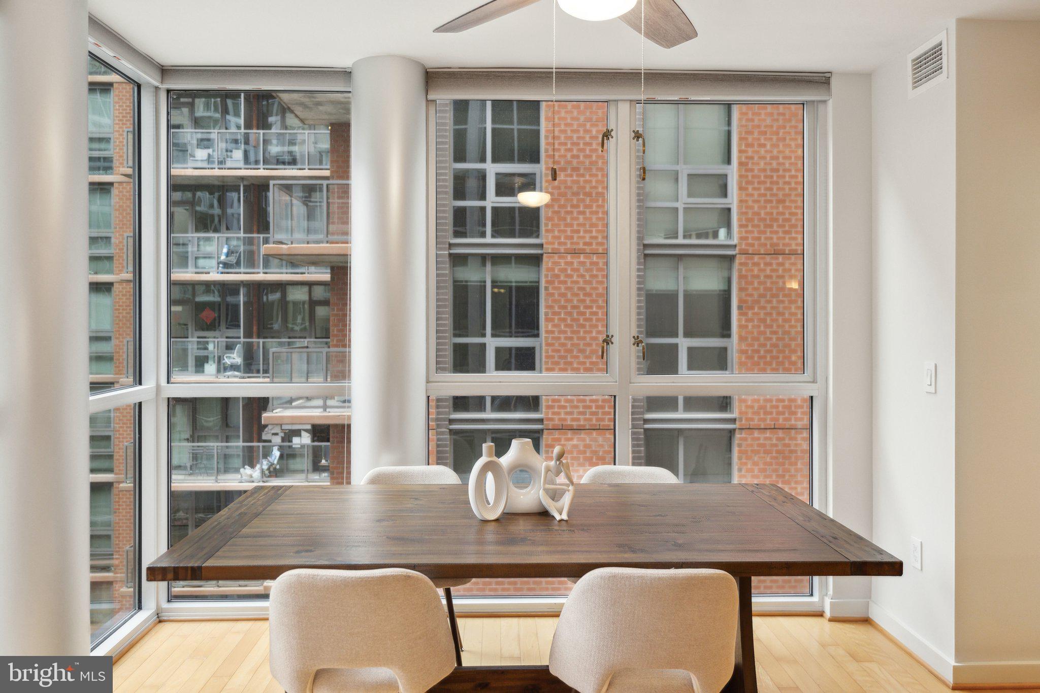 1025 First Street Southeast, Unit 716 Washington, DC 20003 - Photo 6 of 27 a dining room with furniture and wooden floor