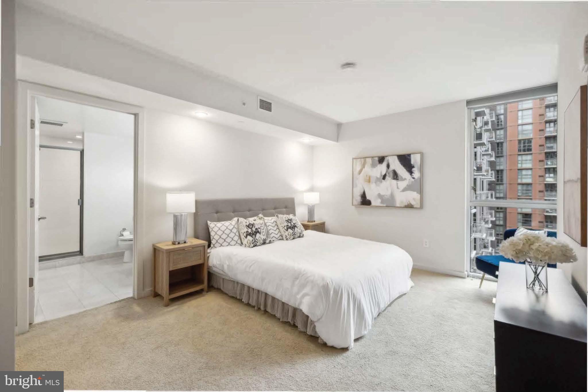 1025 First Street Southeast, Unit 716 Washington, DC 20003 - Photo 7 of 27 a bedroom with a bed and a large mirror