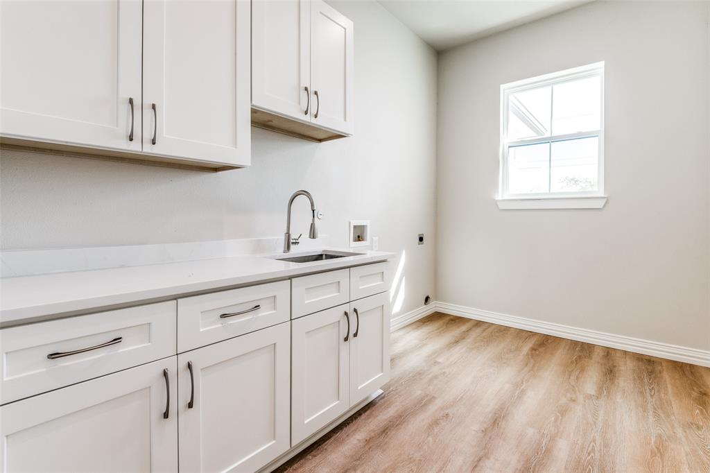 13929 Jackson Road Ponder, TX 76259 - Photo 14 of 16 a kitchen with white cabinets and a wooden floor