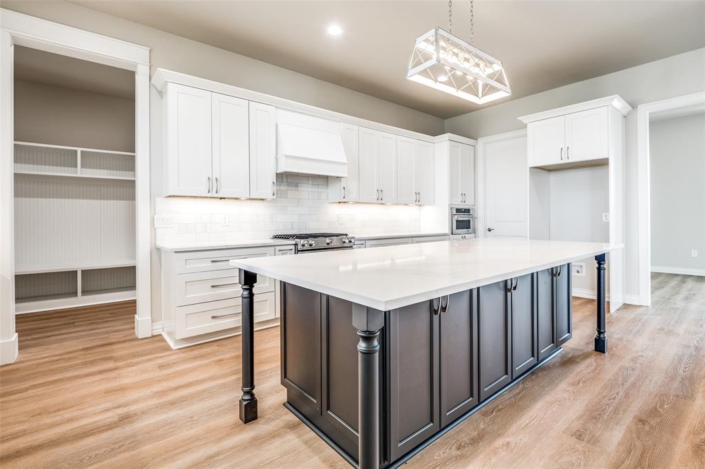 13929 Jackson Road Ponder, TX 76259 - Photo 2 of 16 a kitchen that has a lot of cabinets in it and wooden floors