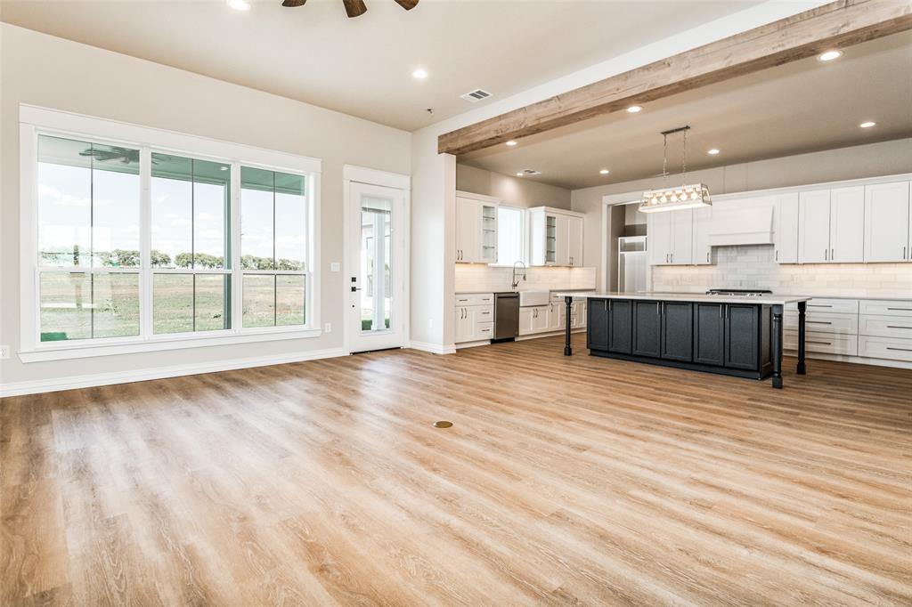 13929 Jackson Road Ponder, TX 76259 - Photo 5 of 16 a large kitchen with stainless steel appliances wooden floors and large window