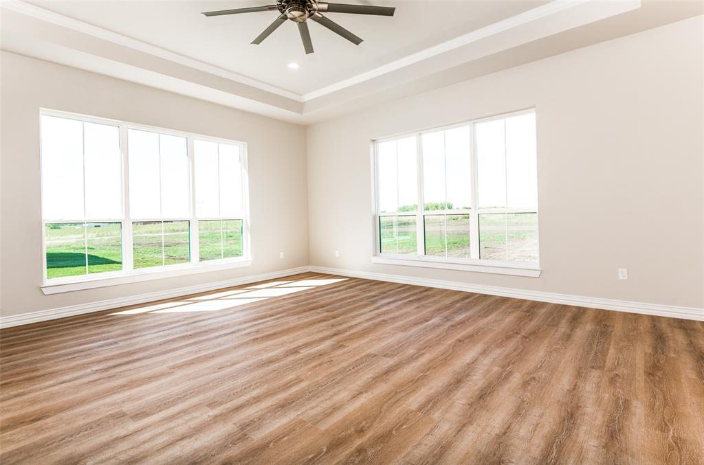 13929 Jackson Road Ponder, TX 76259 - Photo 8 of 16 a view of an empty room with wooden floor and a window