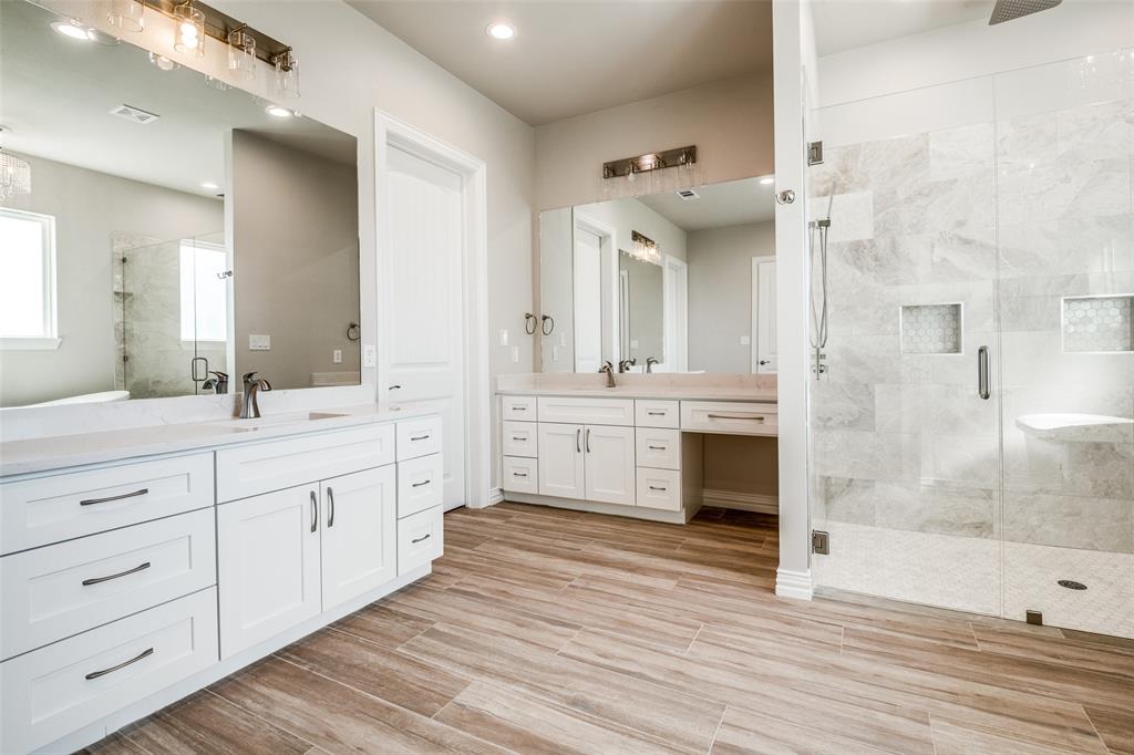13929 Jackson Road Ponder, TX 76259 - Photo 9 of 16 a spacious bathroom with a double vanity sink a mirror and a shower