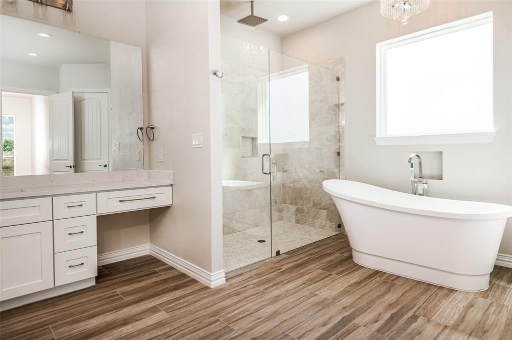 13929 Jackson Road Ponder, TX 76259 - Photo 10 of 16 a bathroom with a white tub shower vanity and a sink