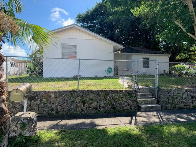 a view of a backyard with plants and a slide