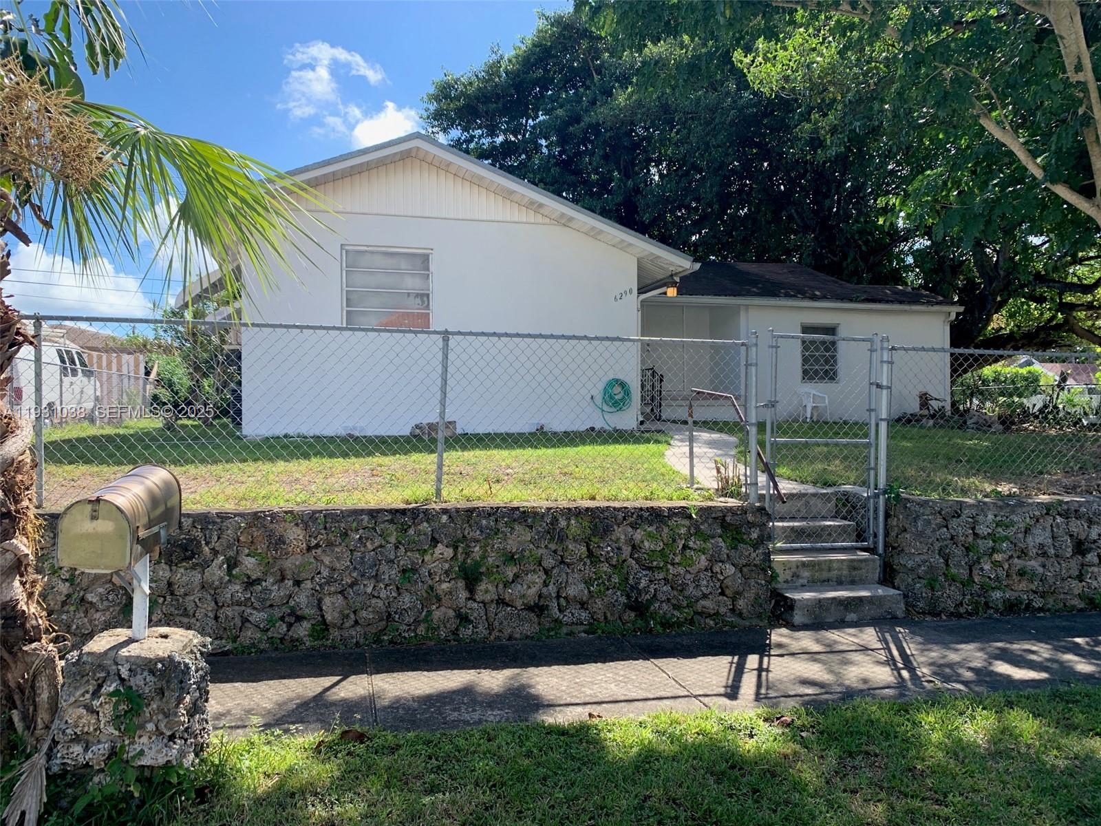 a view of a backyard with plants and a slide