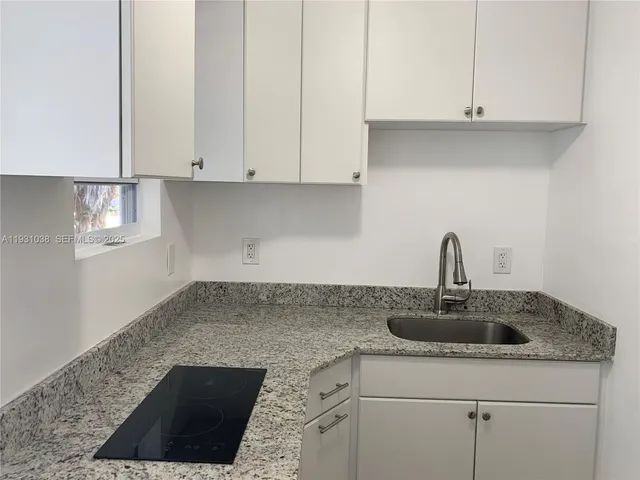 a kitchen with a sink and cabinets