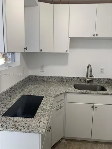 a kitchen with a sink and cabinets