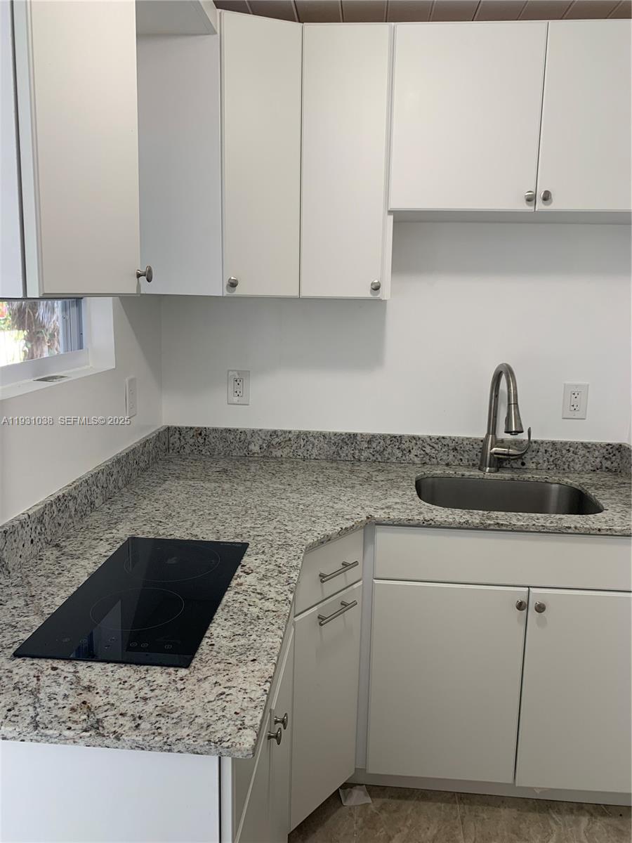 6290 Southwest 39th Street Miami, FL 33155 - Photo 4 of 12 a kitchen with a sink and cabinets