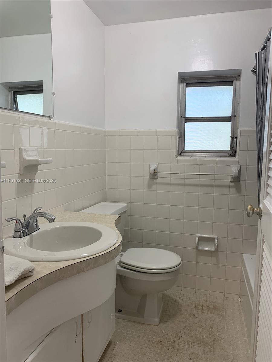 6290 Southwest 39th Street Miami, FL 33155 - Photo 10 of 12 a bathroom with a sink a toilet and mirror