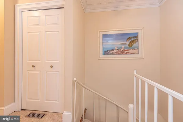 a room with a bed and a mirror on dresser