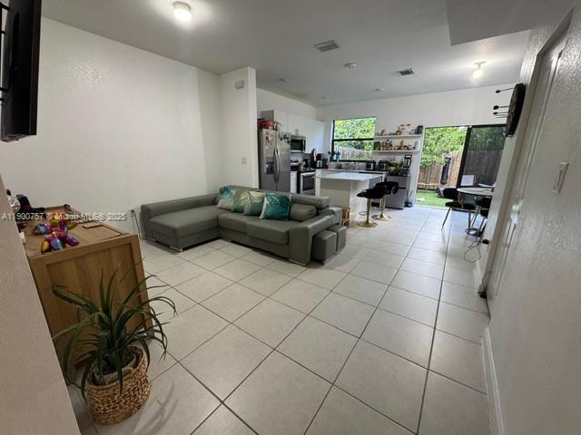 13241 Southwest 285th Street Homestead, FL 33033 - Photo 7 of 14 a living room with furniture and a flat screen tv