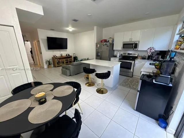 a kitchen with sink a stove and chairs