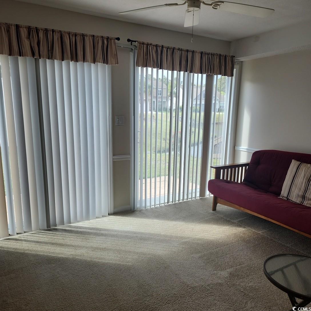 1300 Deer Creek Road, Unit C Surfside Beach, SC 29575 - Photo 11 of 18 Carpeted living area featuring ceiling fan
