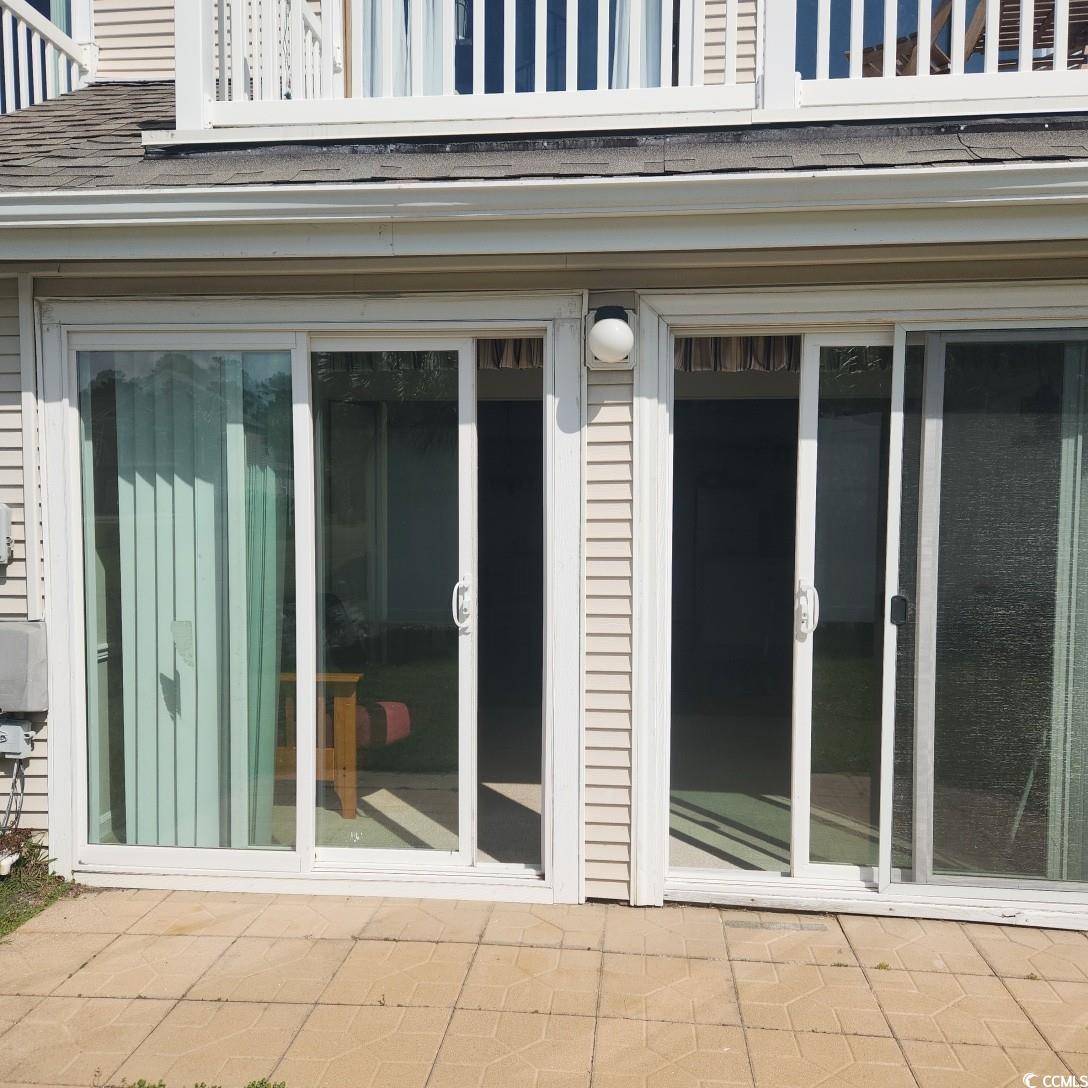 1300 Deer Creek Road, Unit C Surfside Beach, SC 29575 - Photo 18 of 18 Entrance to property featuring a patio and a shingled roof