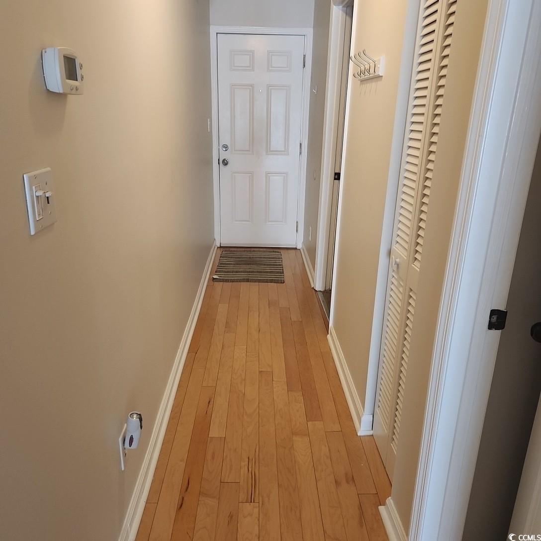 1300 Deer Creek Road, Unit C Surfside Beach, SC 29575 - Photo 4 of 18 Corridor with baseboards and light wood-style flooring