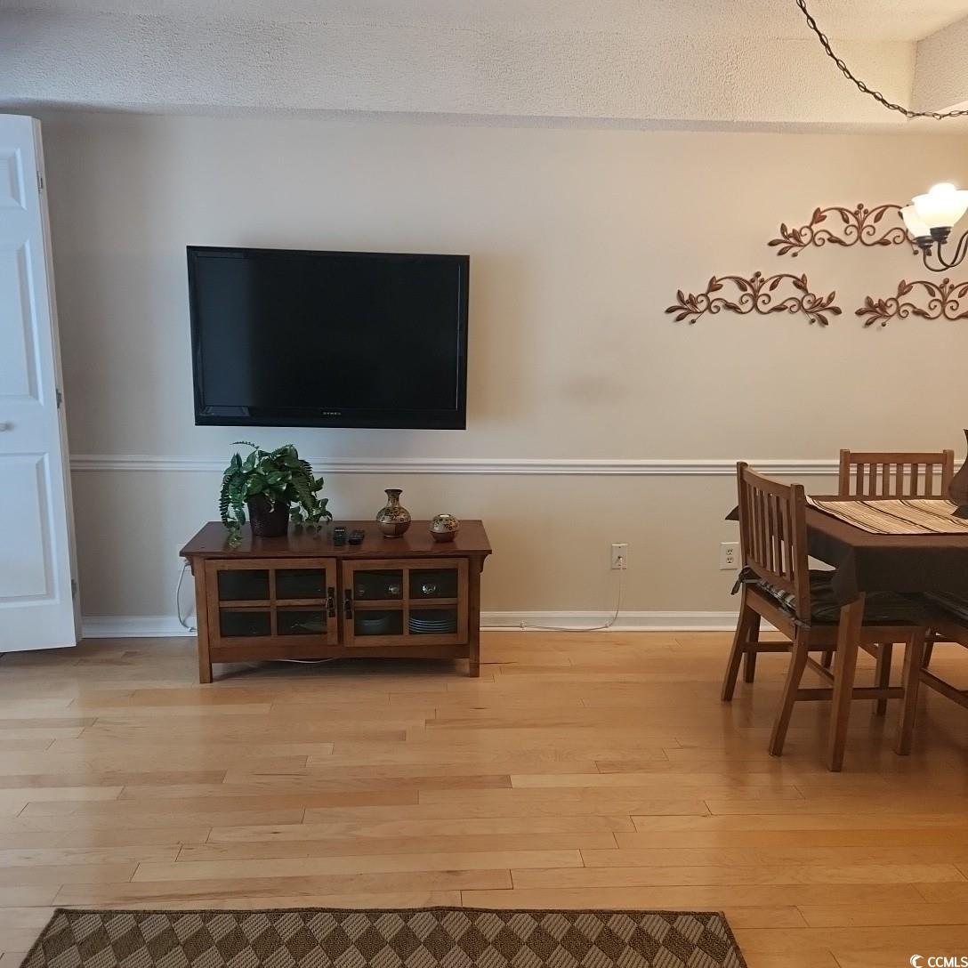 1300 Deer Creek Road, Unit C Surfside Beach, SC 29575 - Photo 9 of 18 Dining space featuring light wood-style floors and a chandelier