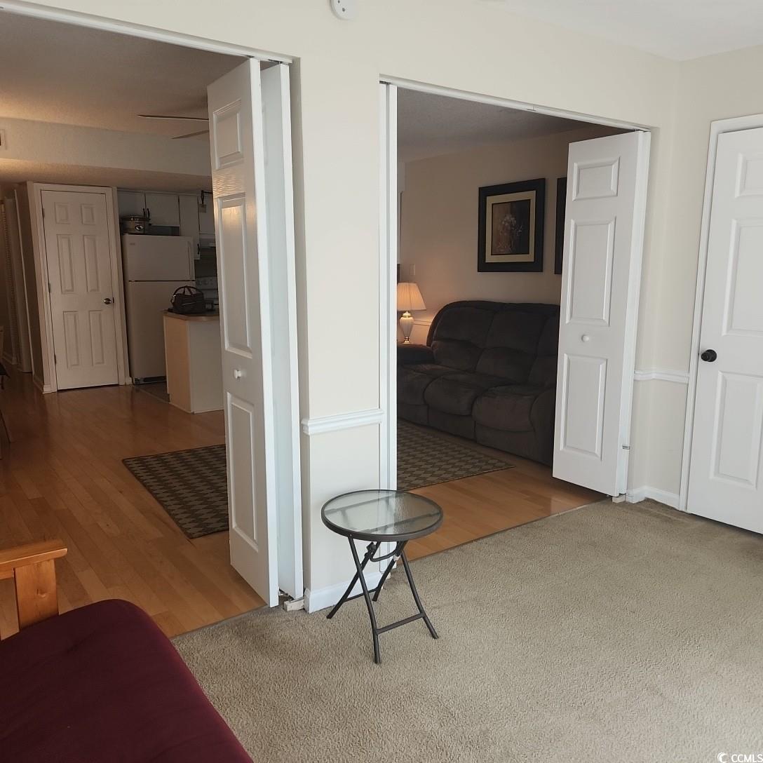 1300 Deer Creek Road, Unit C Surfside Beach, SC 29575 - Photo 10 of 18 Hall with light wood-style flooring
