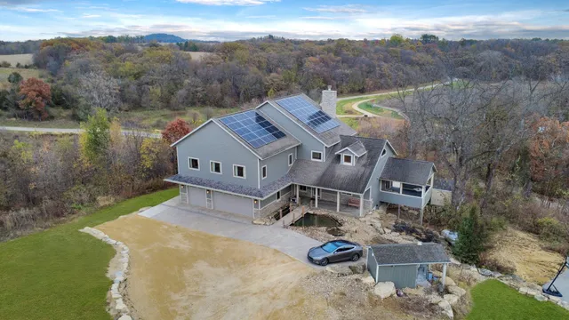 an aerial view of a house with swimming pool and mountain view