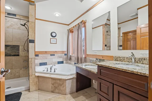 a bathroom with a bathtub sink and mirror