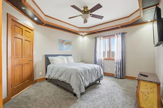 a spacious bedroom with a bed and a chandelier