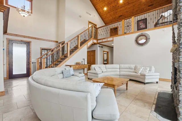 a living room with couches and a table with rug