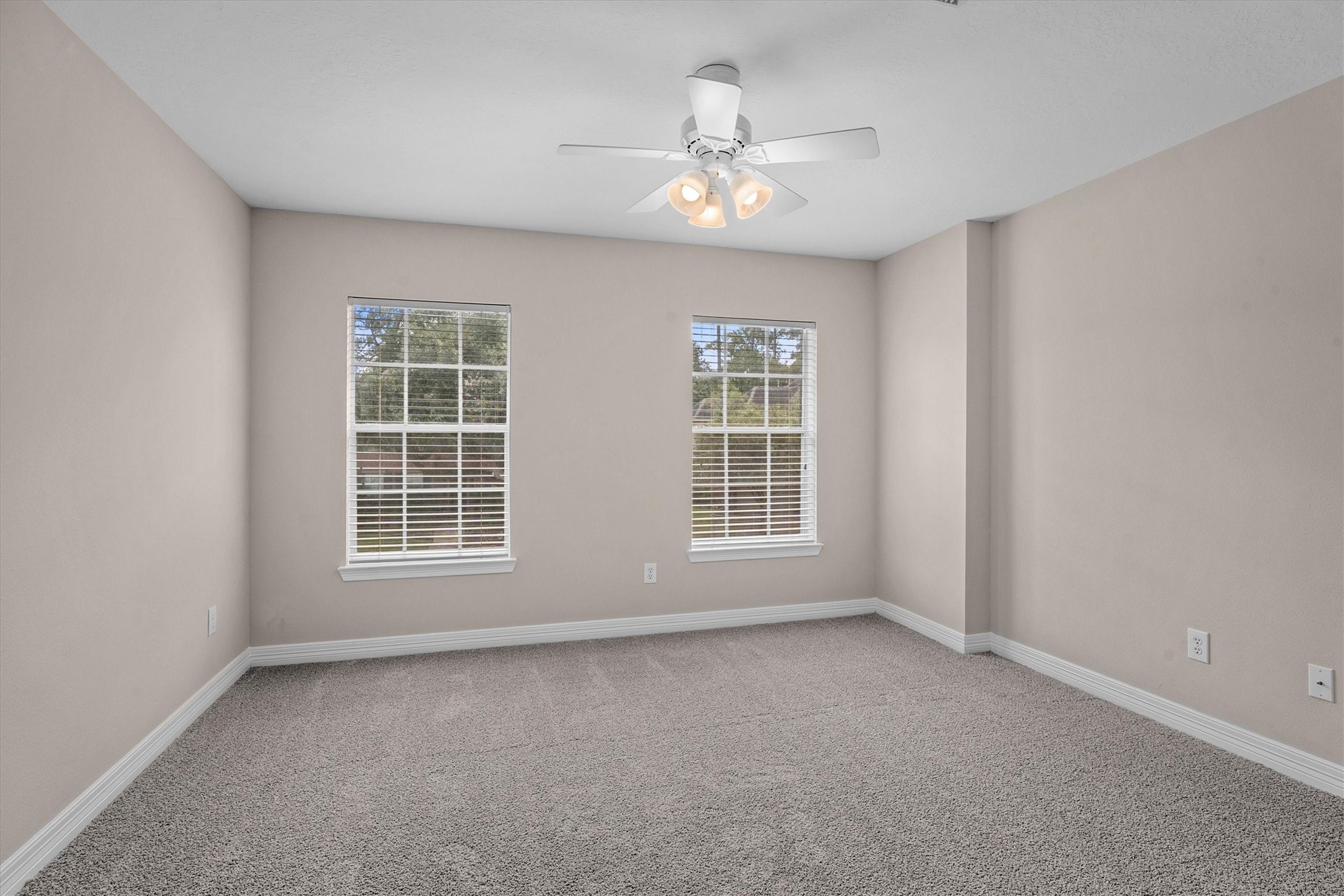 14914 Codys Run Cypress, TX 77429 - Photo 30 of 44 an empty room with chandelier fan and windows