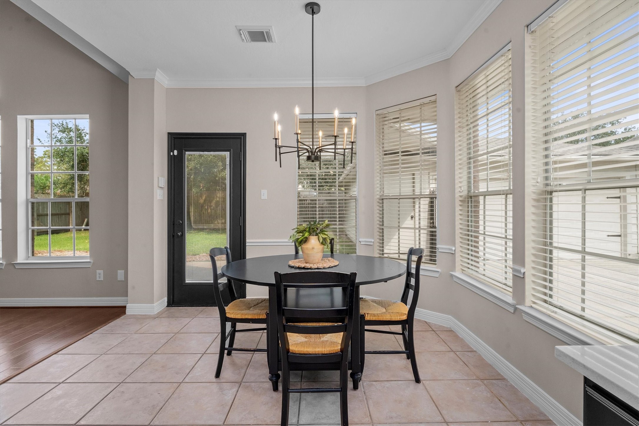 14914 Codys Run Cypress, TX 77429 - Photo 9 of 44 a dining room with furniture a chandelier and wooden floor
