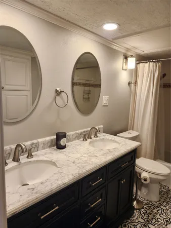 a bathroom with a double vanity sink and a mirror