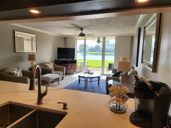 a kitchen with granite countertop a refrigerator and a sink