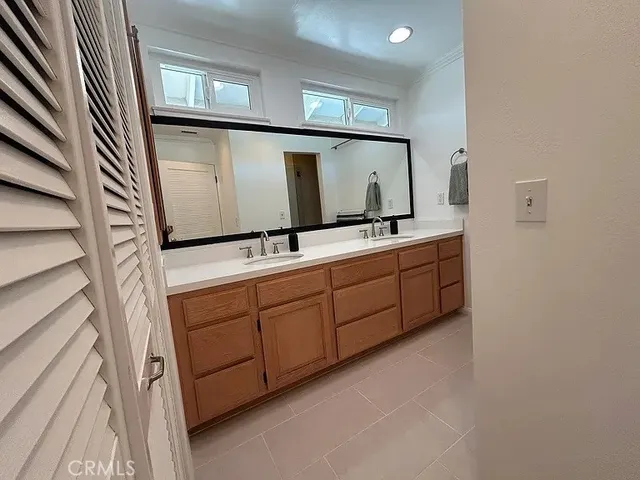 a bathroom with a double vanity sink and mirror
