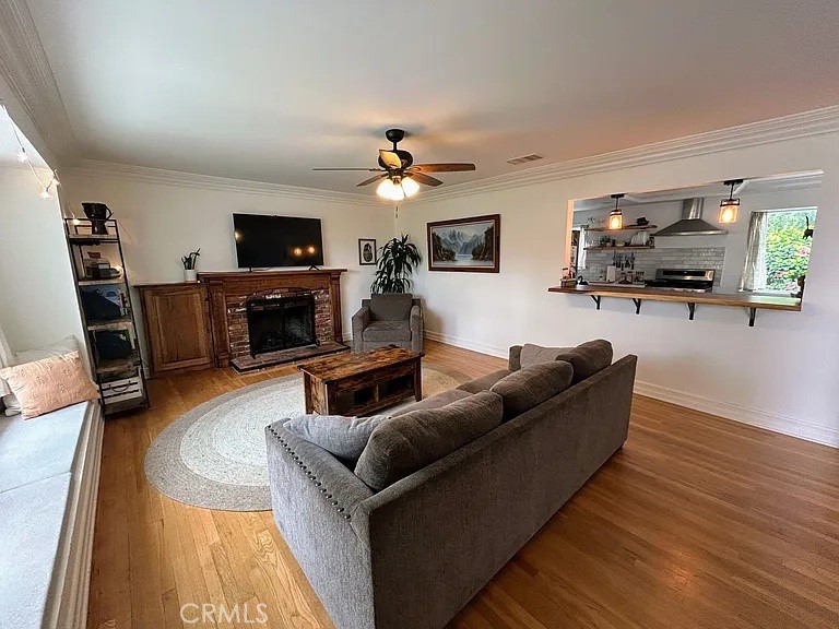 3816 Hartung Court Newbury Park, CA 91320 - Photo 3 of 19 a living room with furniture a flat screen tv and a fireplace