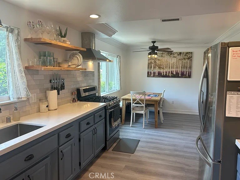 3816 Hartung Court Newbury Park, CA 91320 - Photo 5 of 19 a living room with stainless steel appliances kitchen island granite countertop furniture a large window and a sink