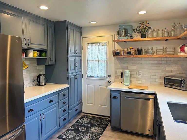 3816 Hartung Court Newbury Park, CA 91320 - Photo 6 of 19 a kitchen with stainless steel appliances granite countertop a sink stove and refrigerator