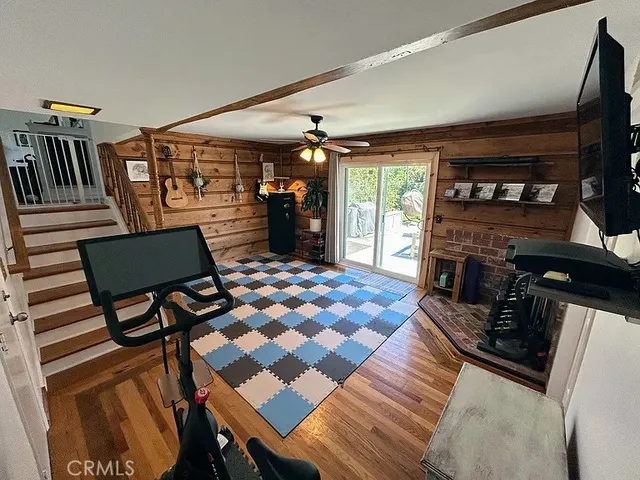 a room with furniture a flat screen tv and rug