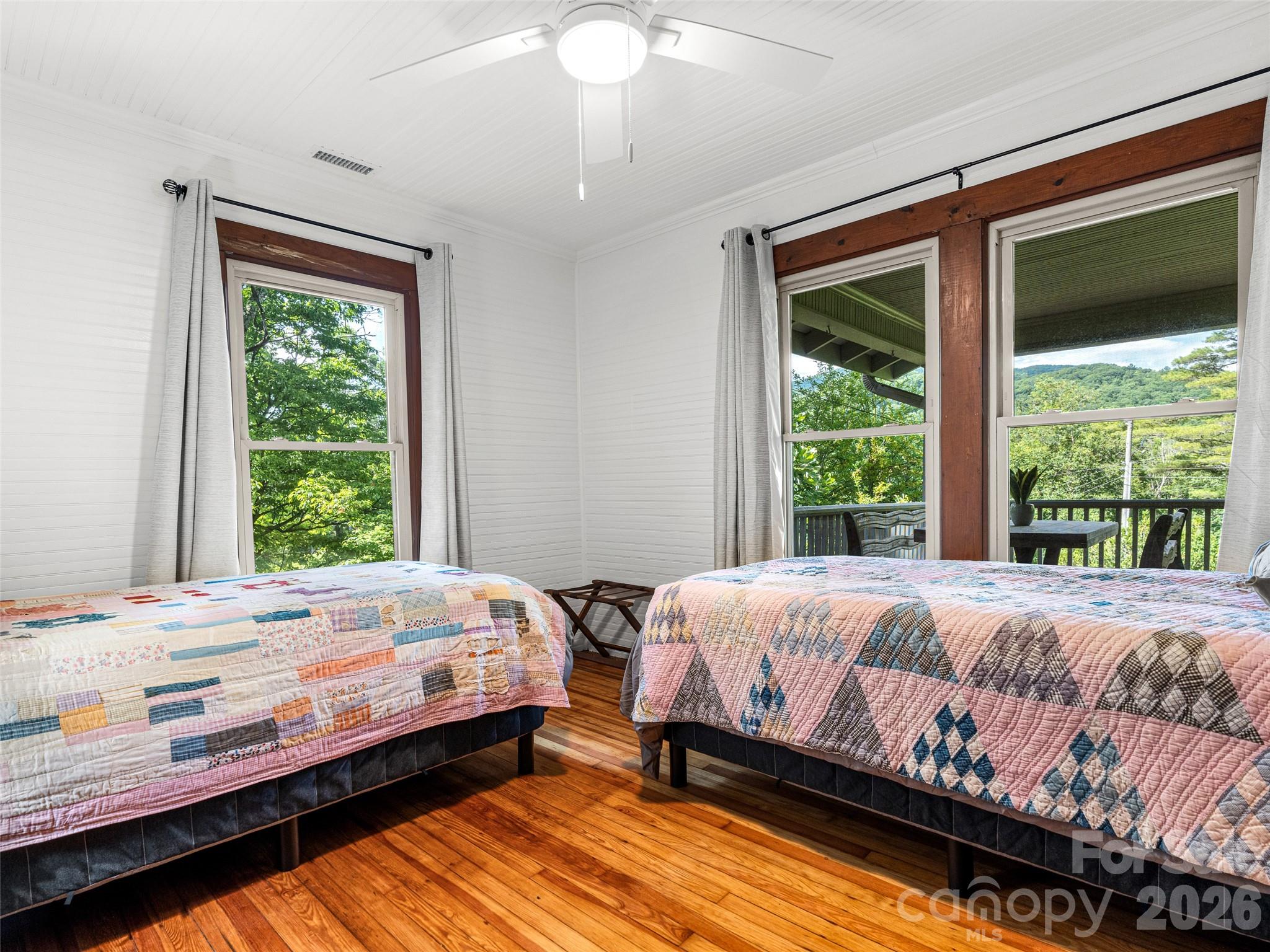 206 Chestnut Hill Road Gerton, NC 28735 - Photo 32 of 48 a bedroom with a bed wooden floor and window