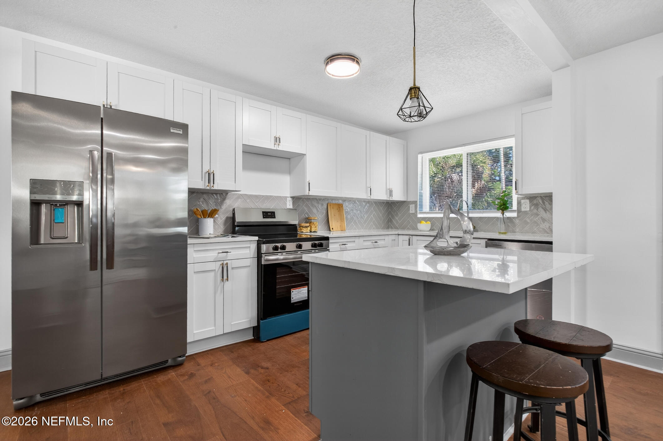 113 Menendez Road St. Augustine, FL 32080 - Photo 18 of 71 a kitchen with stainless steel appliances granite countertop a sink a stove a refrigerator cabinets and a dining table