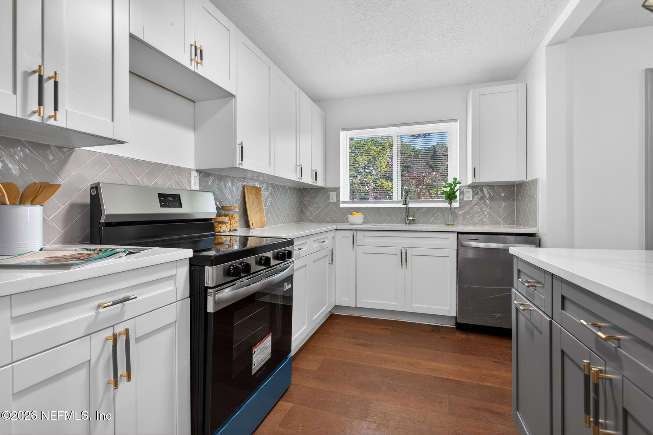 113 Menendez Road St. Augustine, FL 32080 - Photo 19 of 71 a kitchen with a stove a sink and a window