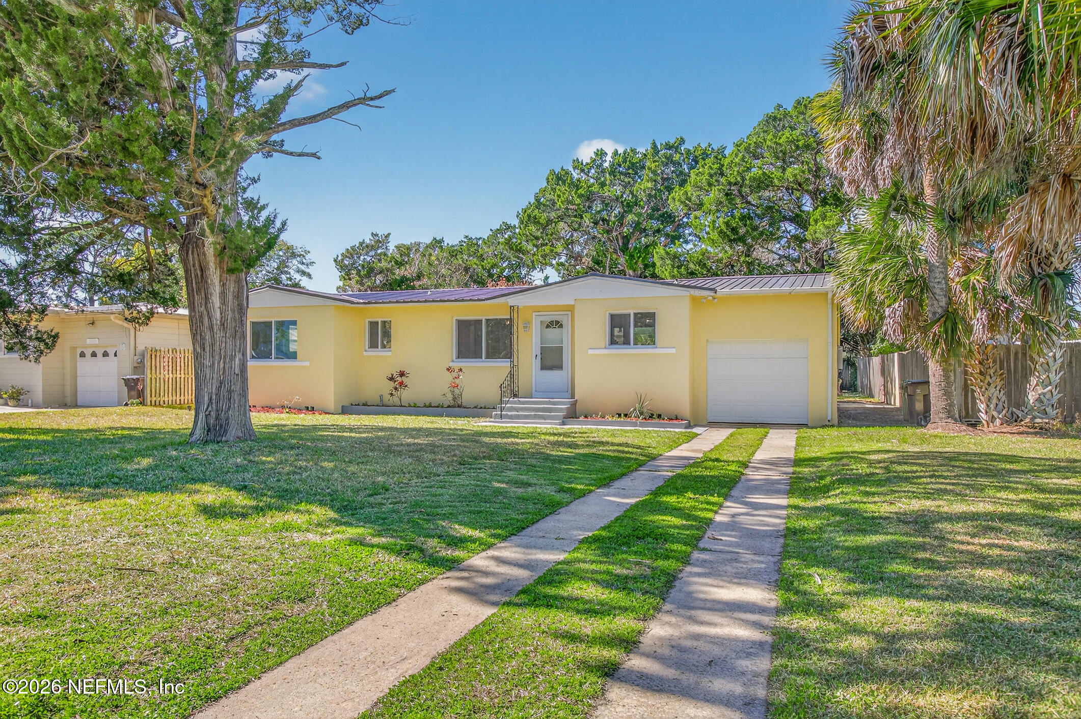 113 Menendez Road St. Augustine, FL 32080 - Photo 2 of 71 a view of a backyard with plants and a large tree