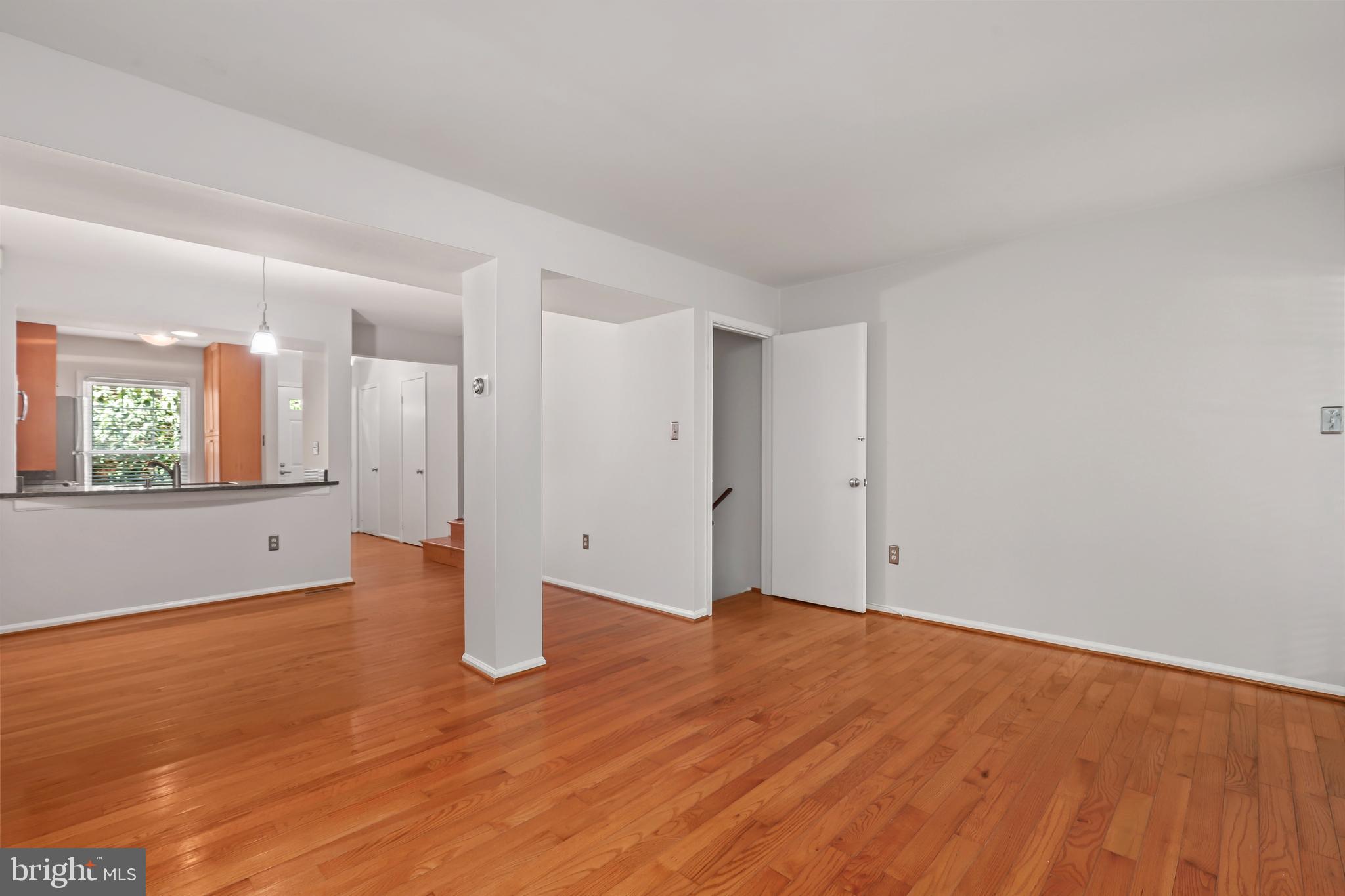 2434 South Walter Reed Drive, Unit 3 Arlington, VA 22206 - Photo 12 of 36 a view of an empty room with wooden floor and a window