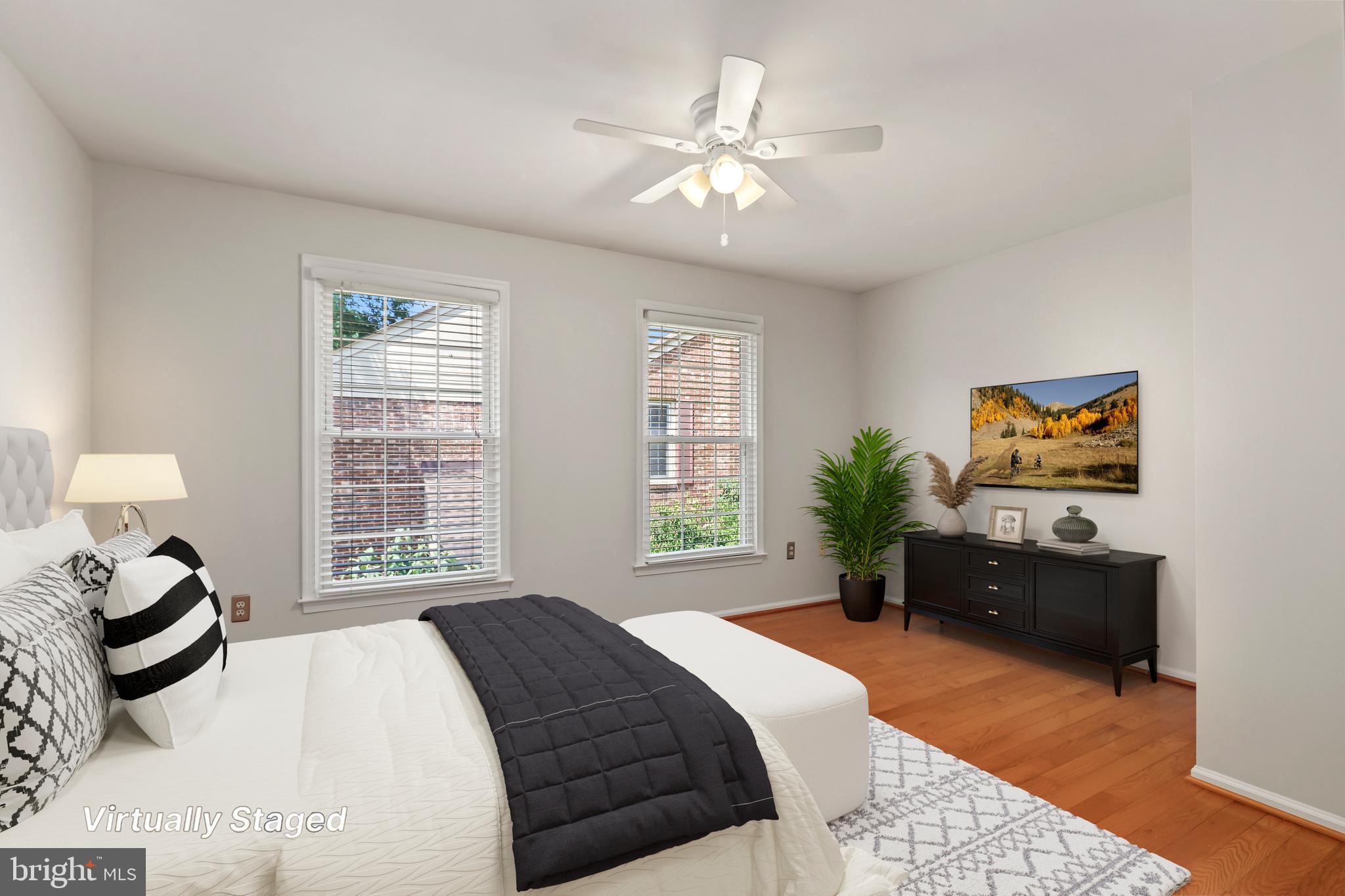 2434 South Walter Reed Drive, Unit 3 Arlington, VA 22206 - Photo 20 of 36 a bedroom with a bed and dresser with mirror