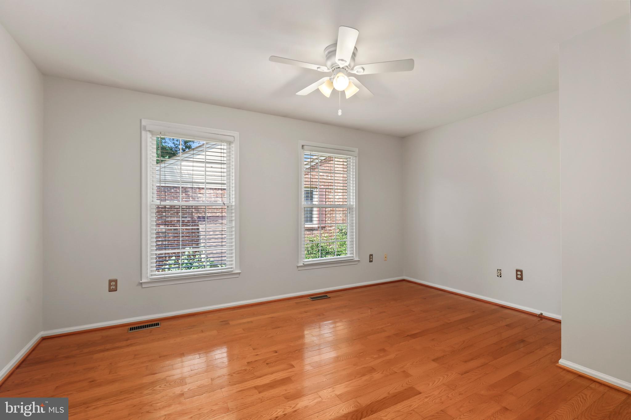 2434 South Walter Reed Drive, Unit 3 Arlington, VA 22206 - Photo 21 of 36 an empty room with windows and fan