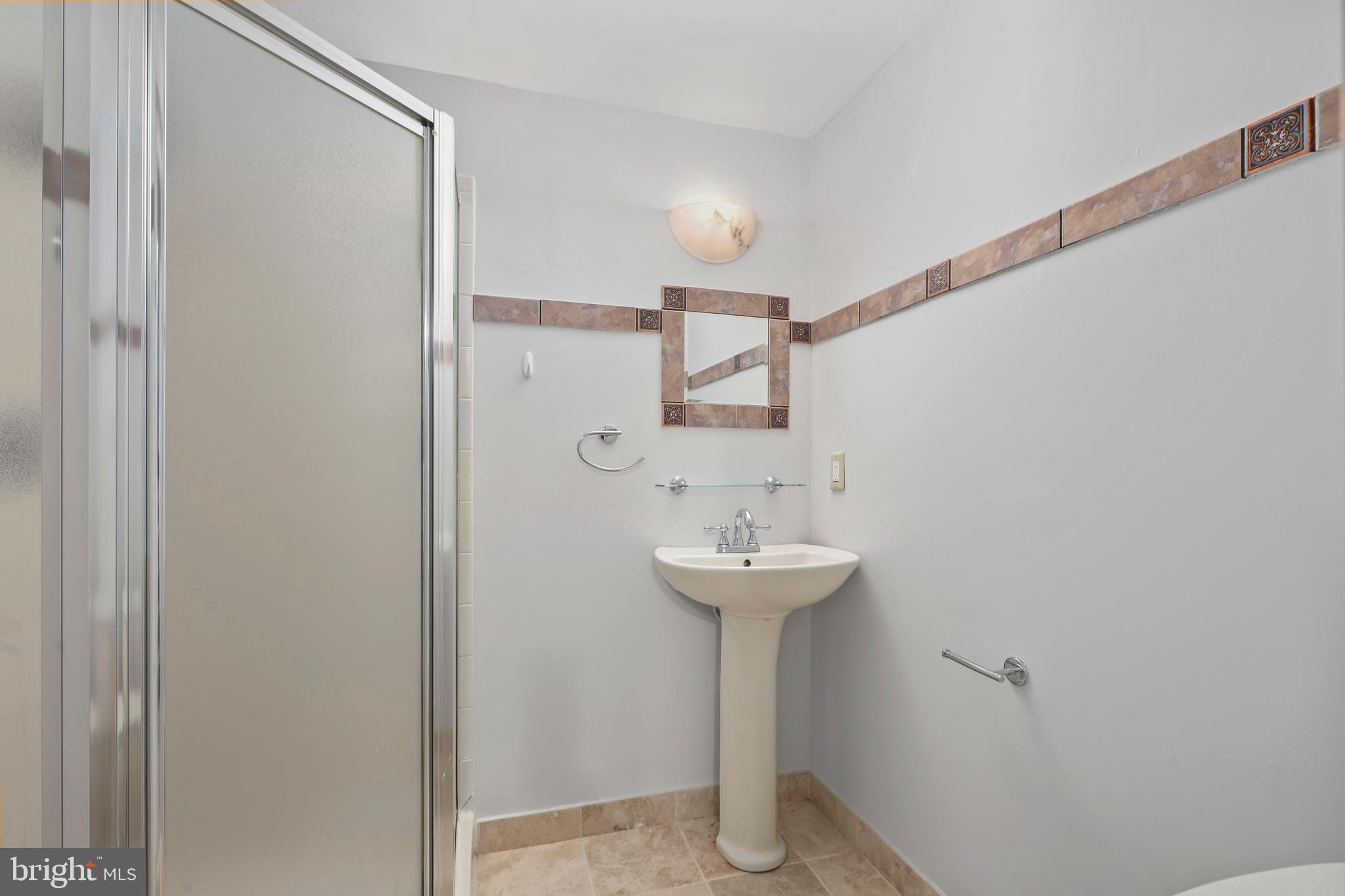 2434 South Walter Reed Drive, Unit 3 Arlington, VA 22206 - Photo 24 of 36 a bathroom with a sink a mirror and shower