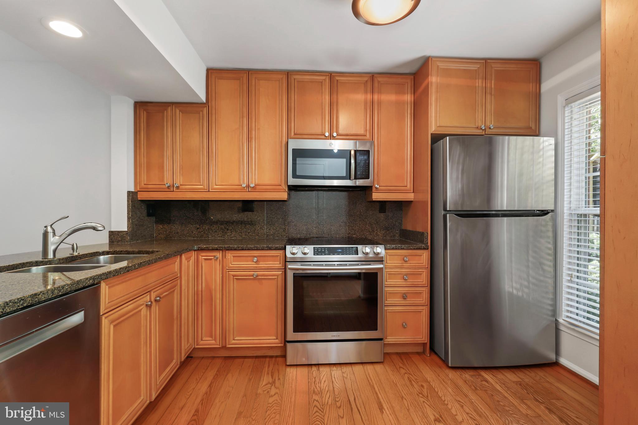 2434 South Walter Reed Drive, Unit 3 Arlington, VA 22206 - Photo 3 of 36 a kitchen with a refrigerator sink and cabinets