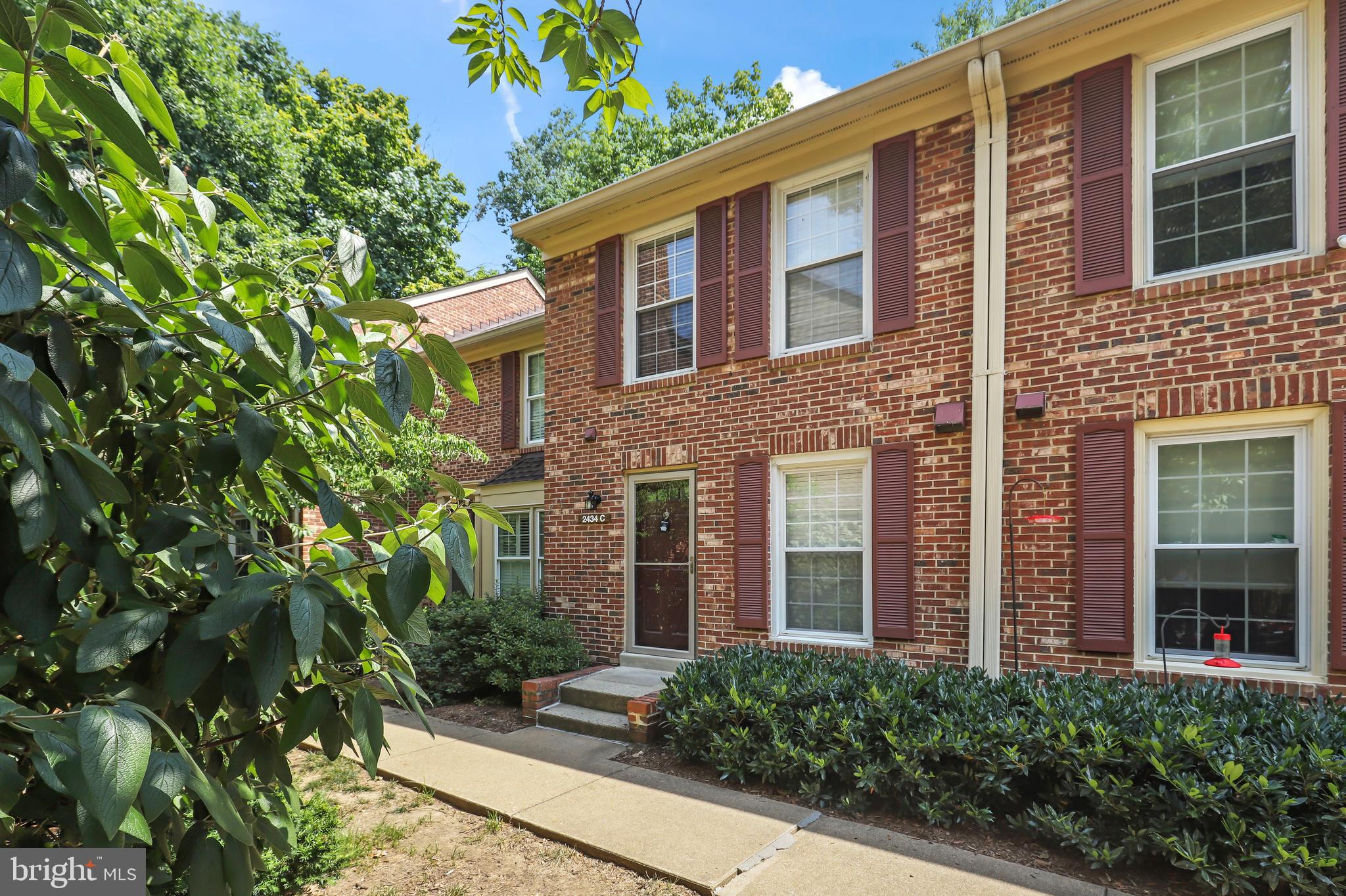 2434 South Walter Reed Drive, Unit 3 Arlington, VA 22206 - Photo 31 of 36 front view of a brick house with a large windows