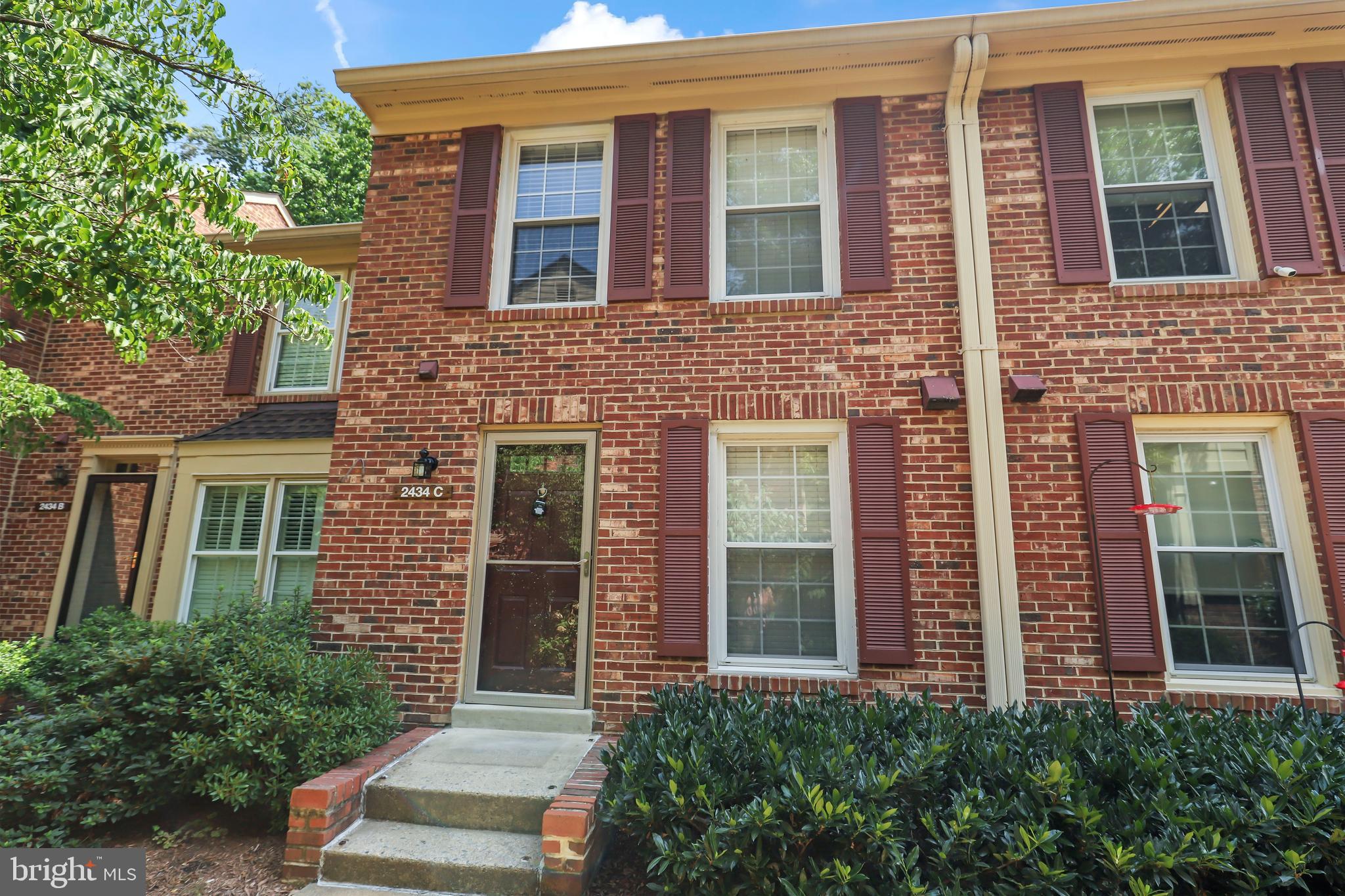 2434 South Walter Reed Drive, Unit 3 Arlington, VA 22206 - Photo 32 of 36 front view of a brick house with a large windows