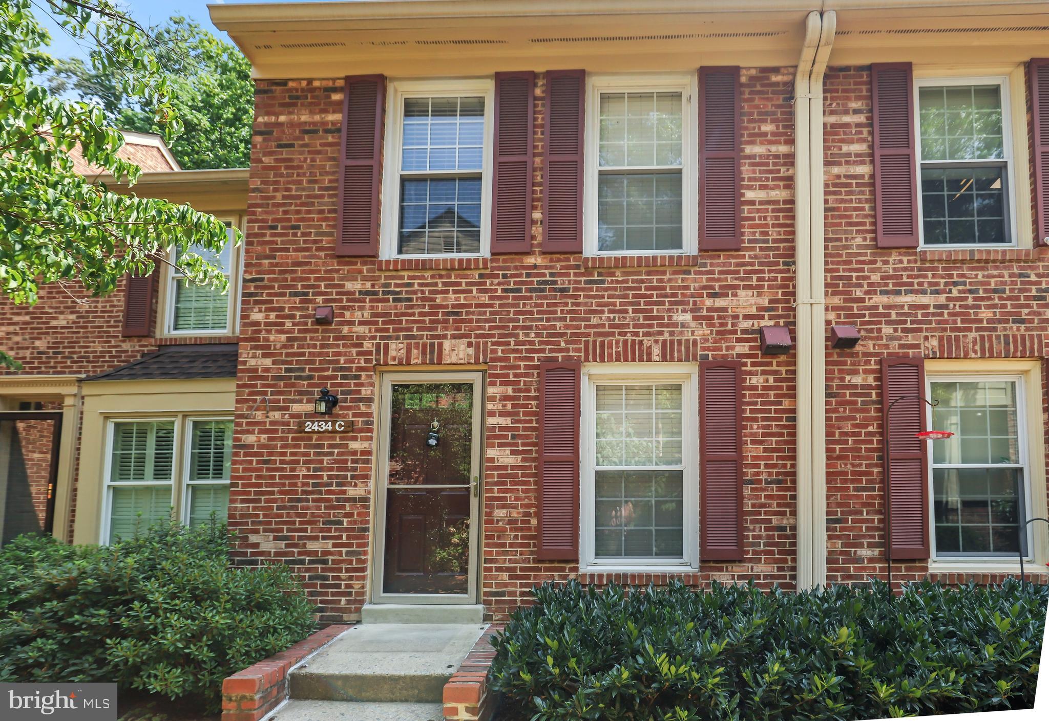 2434 South Walter Reed Drive, Unit 3 Arlington, VA 22206 - Photo 33 of 36 front view of a brick house with a large windows