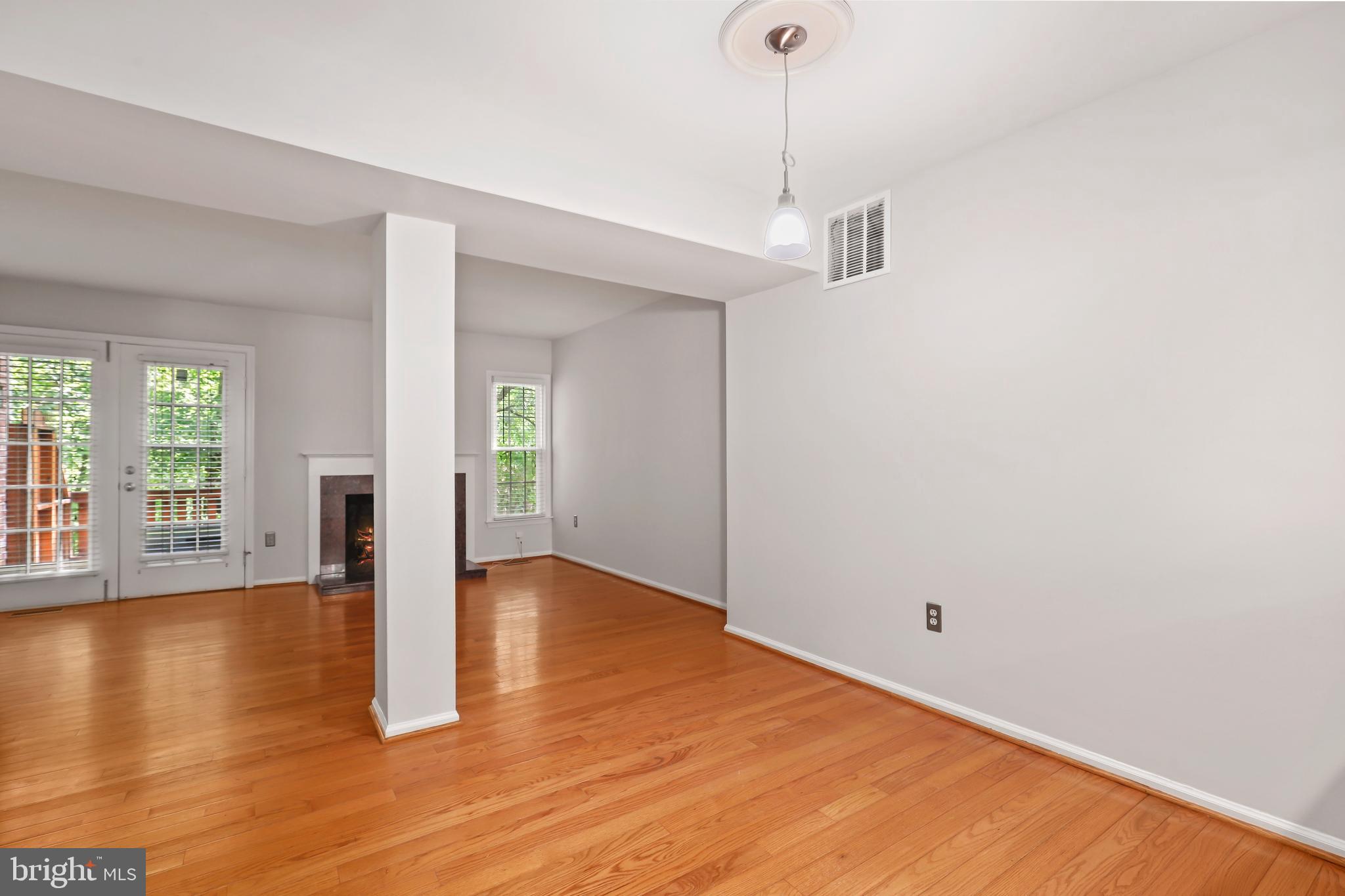 2434 South Walter Reed Drive, Unit 3 Arlington, VA 22206 - Photo 6 of 36 a view of an empty room with window and wooden floor