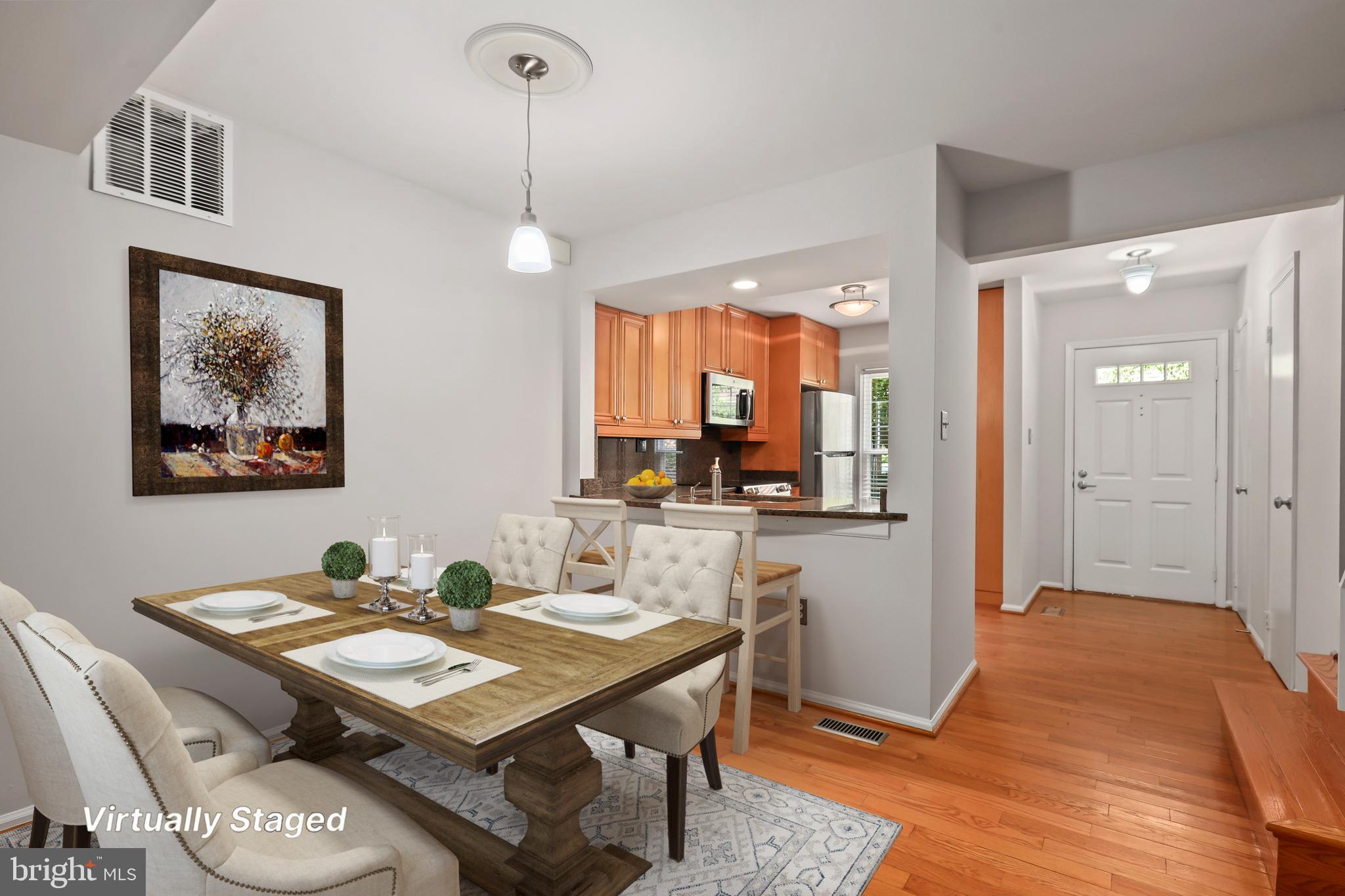 2434 South Walter Reed Drive, Unit 3 Arlington, VA 22206 - Photo 7 of 36 a view of a dining room with furniture window and wooden floor
